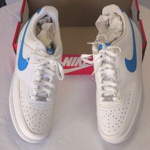 Nike Court Vision Low Next Nature sneakers in white with a blue swoosh.